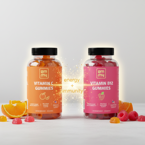 Two bottles of gummy vitamins, one orange and one pink, on a light gray background.